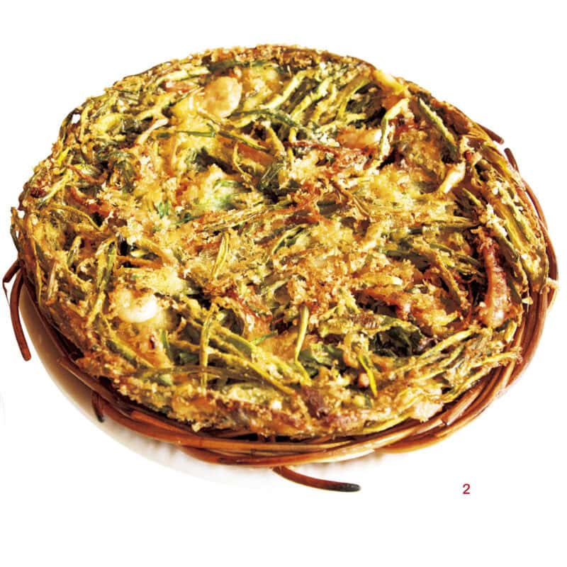 2.ししとうが入った海鮮ネギチヂミ（₩22,000）は厚みがあり、揚げ焼きされた表面はガリッガリで食べ応えあり。かじると中はふんわりという食感の差も楽しめる。